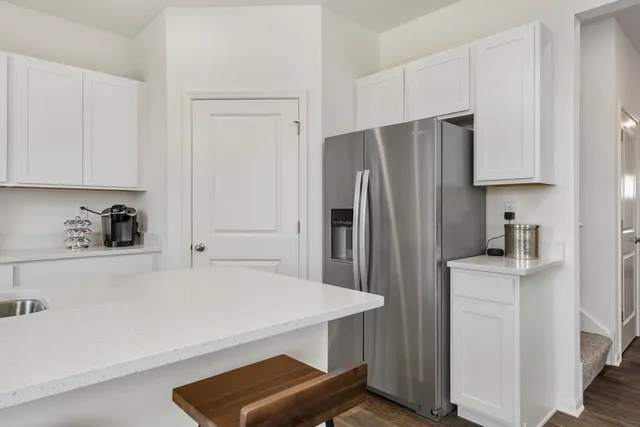 a kitchen with a refrigerator and a sink