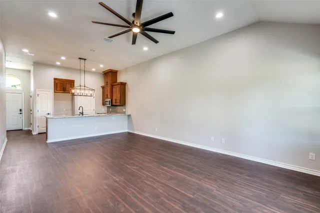 a view of a kitchen with a dishwasher and wooden floor