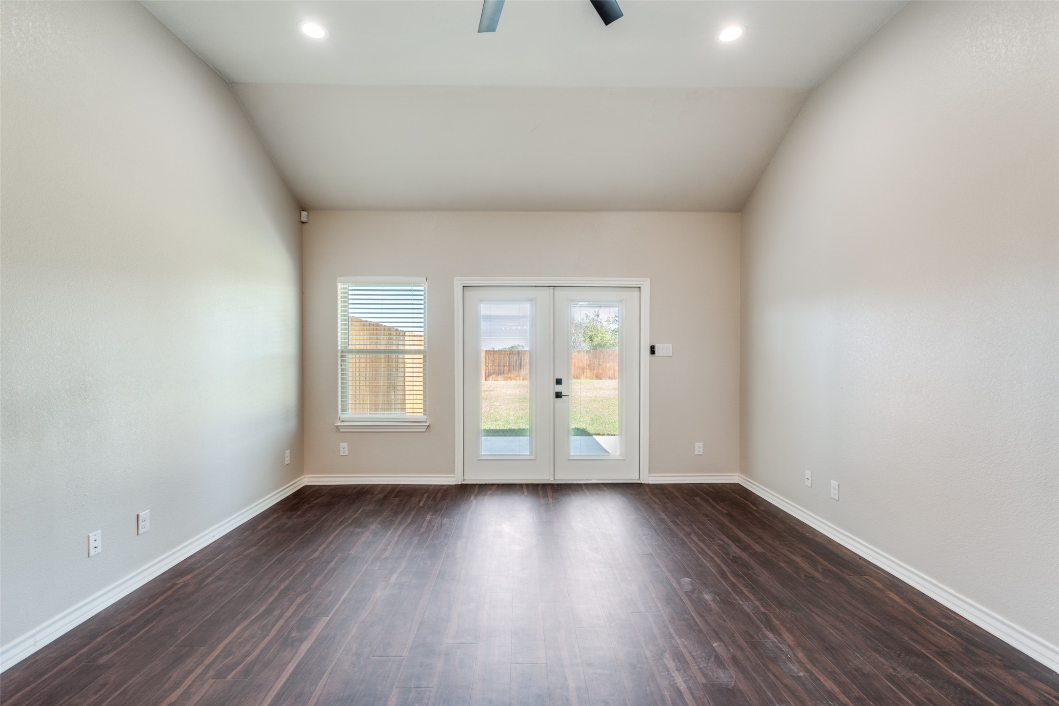 301 Navarro Way, Unit 29B Seguin, TX 78155 - Photo 14 of 26 an empty room with wooden floor and windows