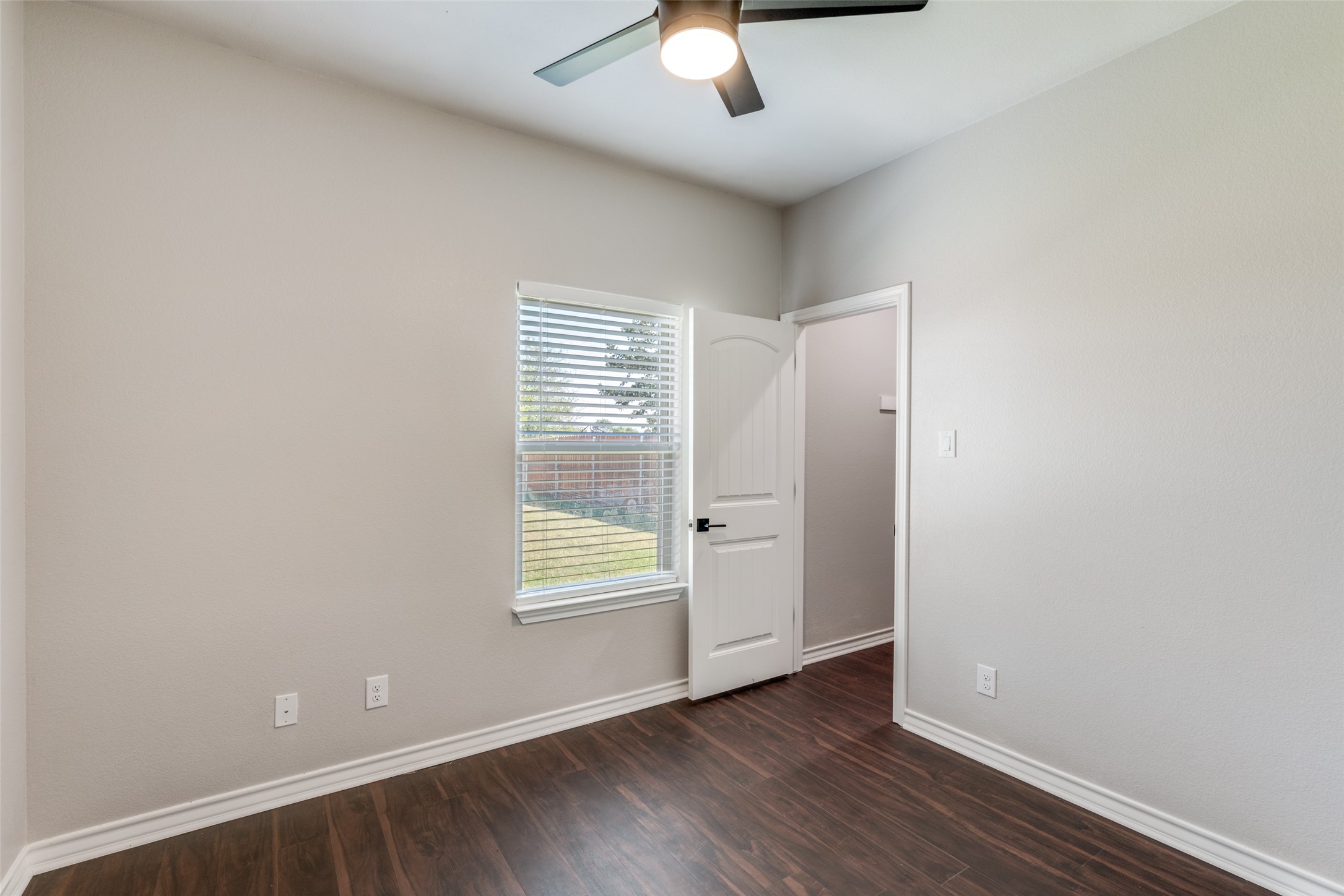 301 Navarro Way, Unit 29B Seguin, TX 78155 - Photo 15 of 26 an empty room with wooden floor closet and windows