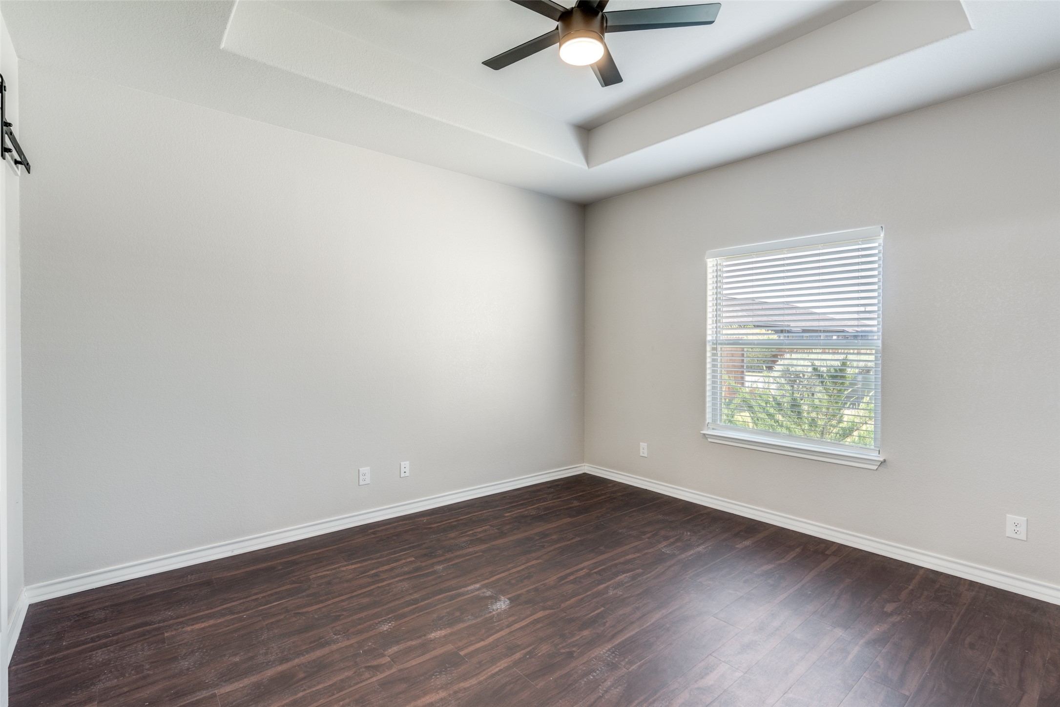 301 Navarro Way, Unit 29B Seguin, TX 78155 - Photo 8 of 26 an empty room with wooden floor and windows