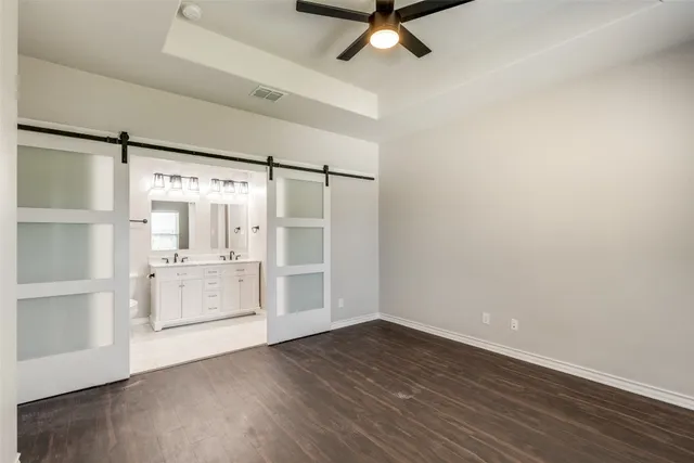 a view of a room with wooden floor and white walls