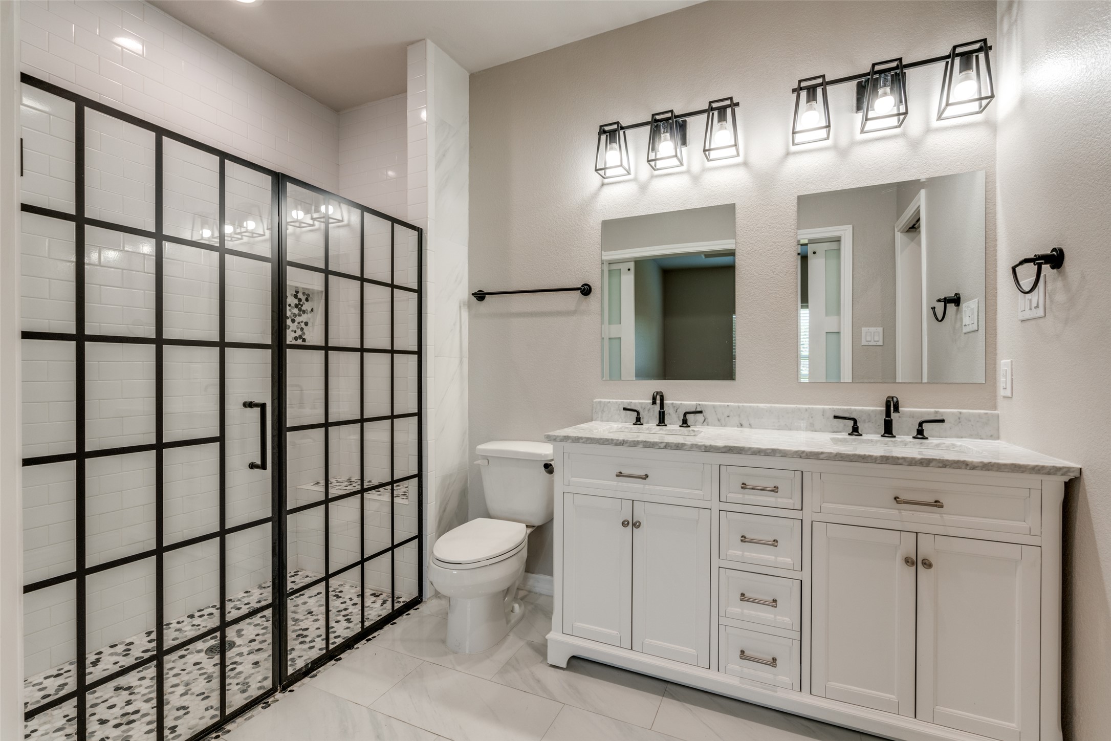 301 Navarro Way, Unit 29B Seguin, TX 78155 - Photo 10 of 26 a bathroom with a double vanity sink a toilet and a mirror