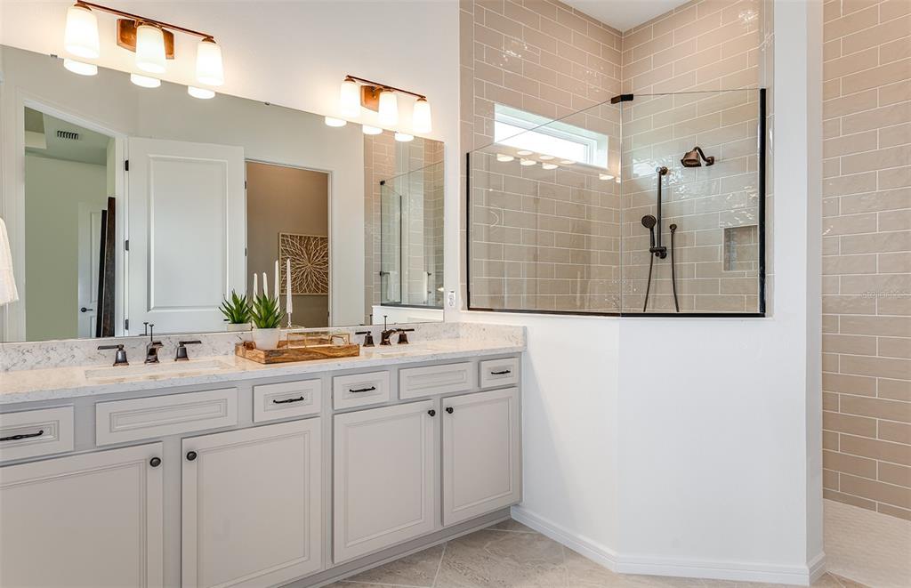 1947 Spring Shower Circle Kissimmee, FL 34744 - Photo 13 of 18 a bathroom with a double vanity sink mirror and shower