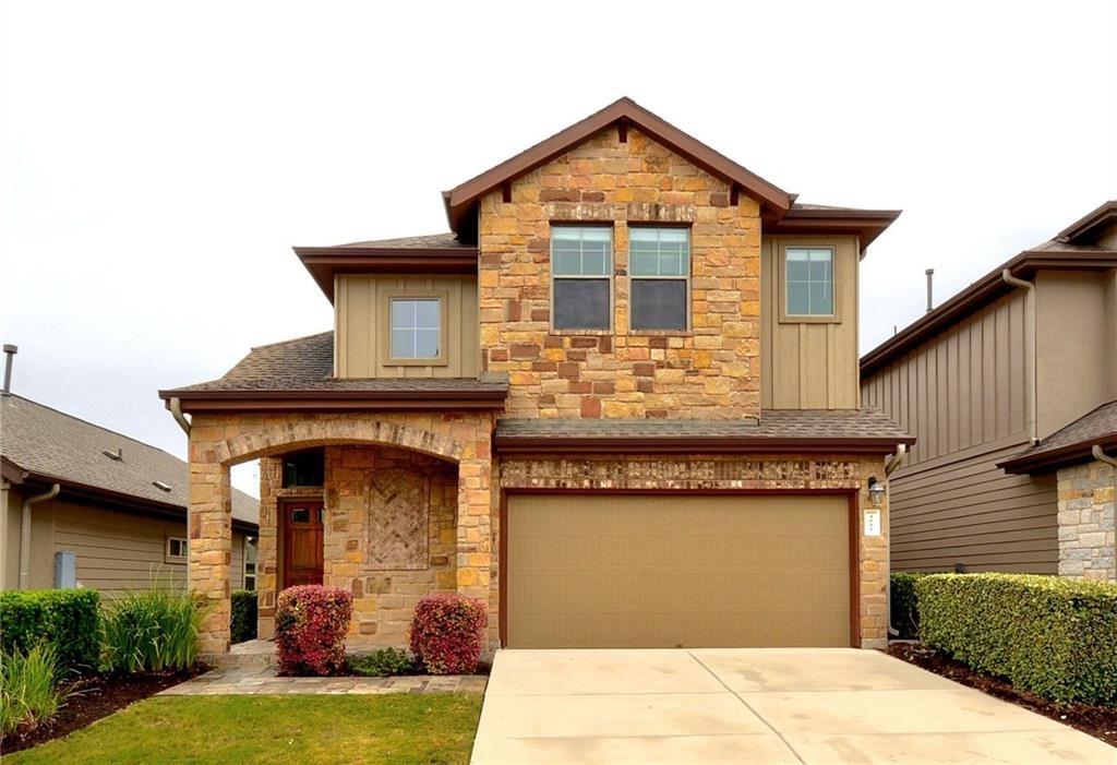 Craftsman-style home with stone siding, a garage, a shingled roof, and driveway