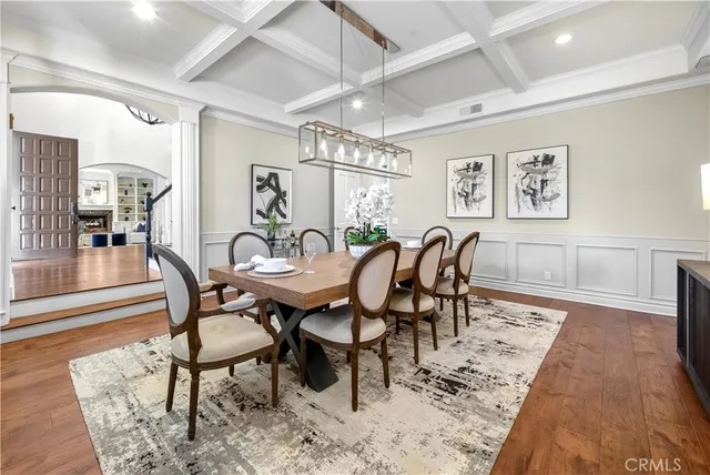 a view of a dining room with furniture and chandelier