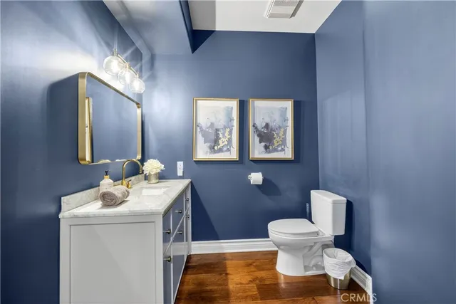 a view of staircase with wooden floor and fan
