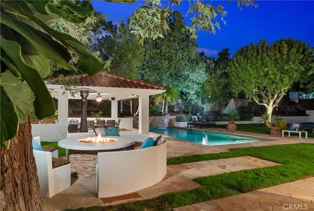 a view of house with swimming pool outdoor seating
