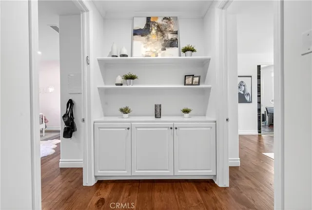 a bedroom with furniture and a wooden floor