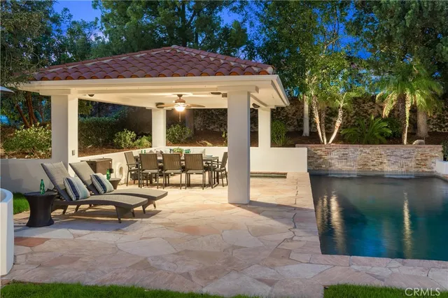 a view of a house with backyard and sitting area