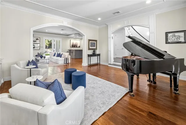 a living room with furniture and wooden floor