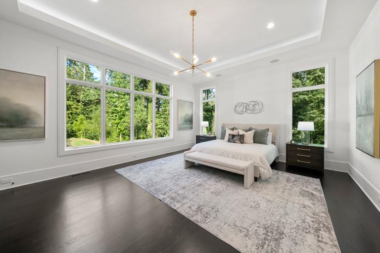5211 Powers Ferry Road Northwest Sandy Springs, GA 30327 - Photo 45 of 106 a bedroom with a large bed and a chandelier