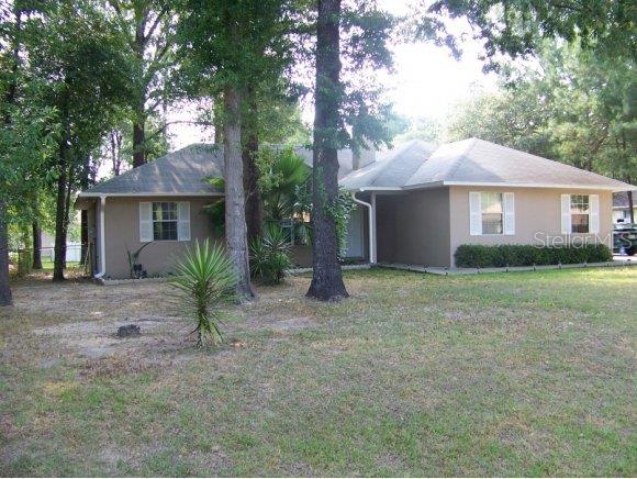 6657 Hemlock Road Ocala, FL 34472 - Photo 1 of 1 a view of a house with a yard and large tree
