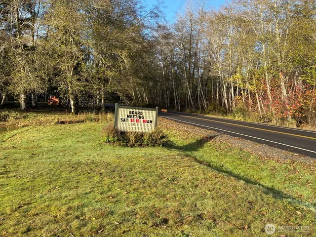 a view of a swimming pool with a bench and trees