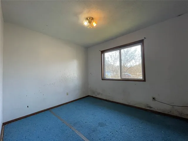 a view of an empty room with closet