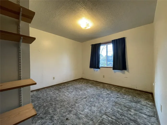 an empty room with closet area