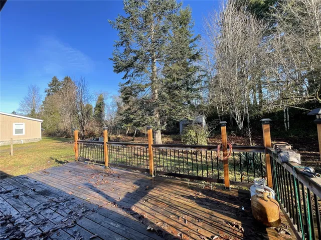 a view of a wooden house with a yard