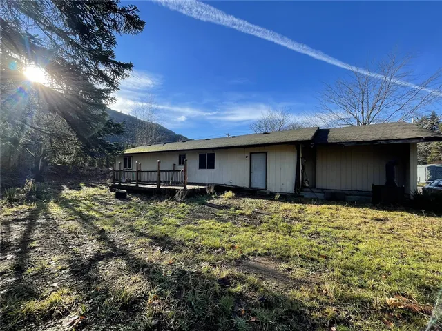 a view of a yard with wooden fence