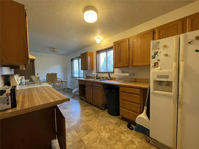 a kitchen with a refrigerator and a sink