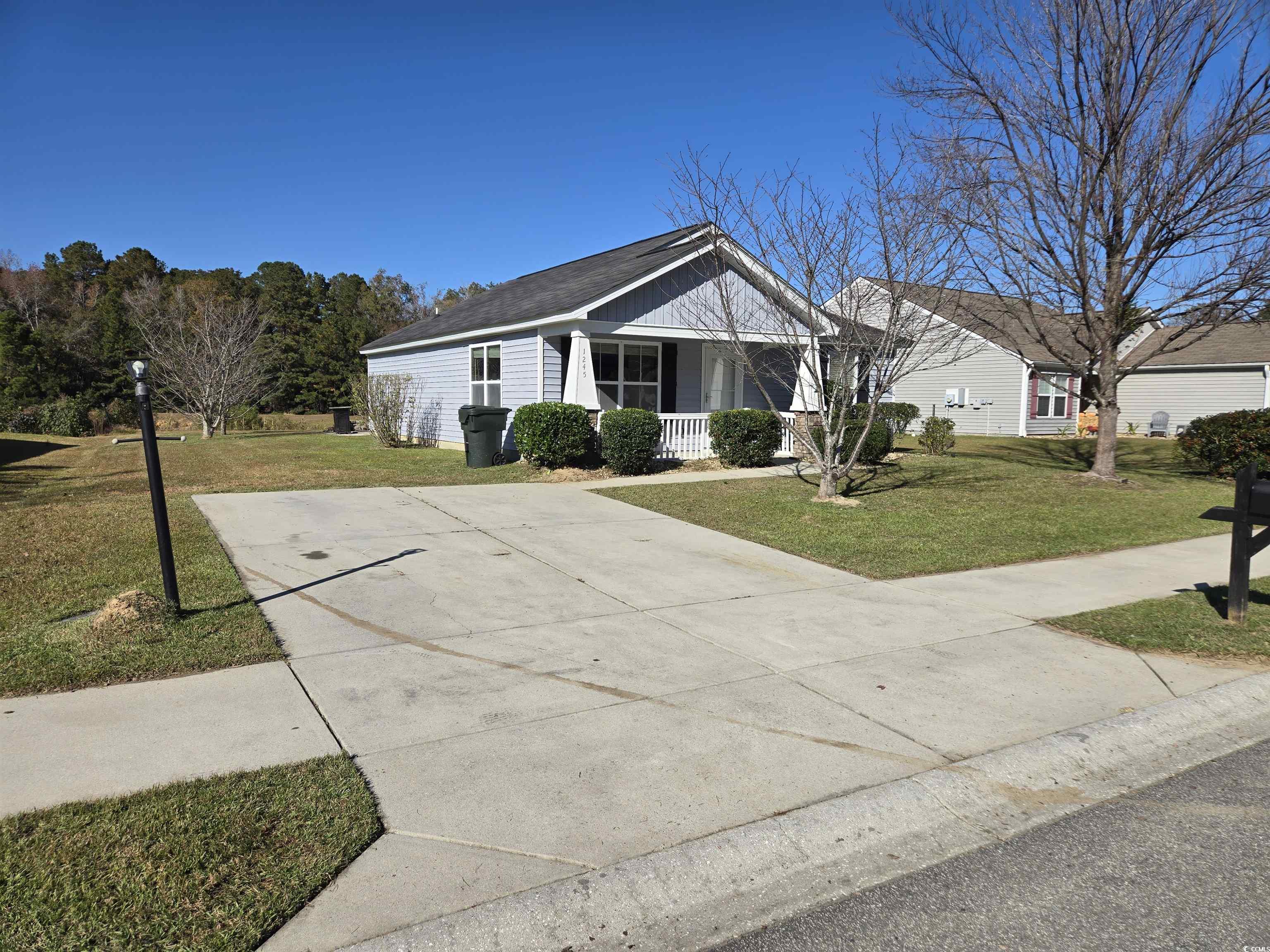 1245 Pine Ridge Street Conway, SC 29527 - Photo 23 of 28 Ranch-style house with covered porch, a front yard, driveway, and a shingled roof