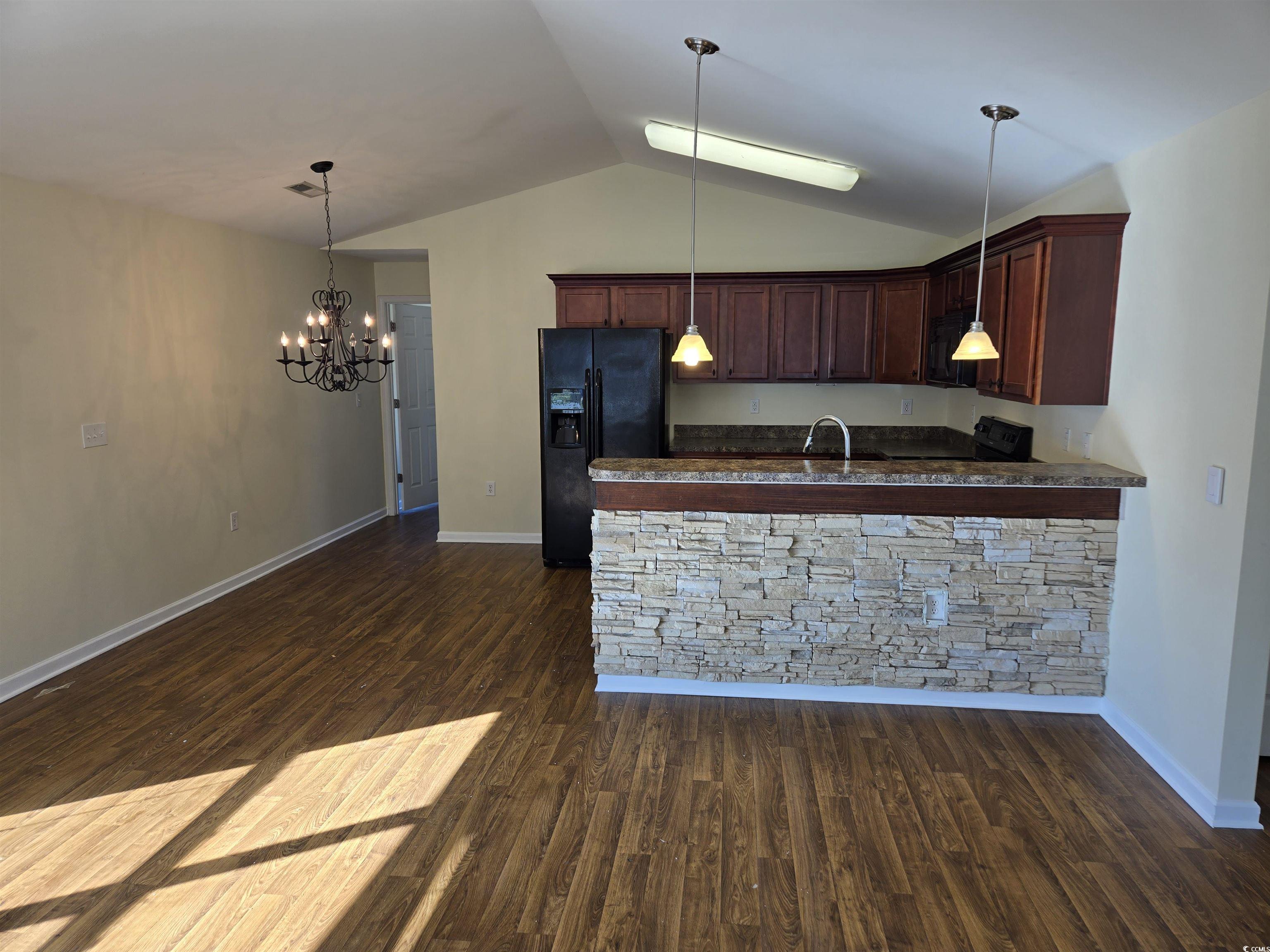 1245 Pine Ridge Street Conway, SC 29527 - Photo 4 of 28 Kitchen featuring pendant lighting, a peninsula, black appliances, lofted ceiling, and dark wood-type flooring