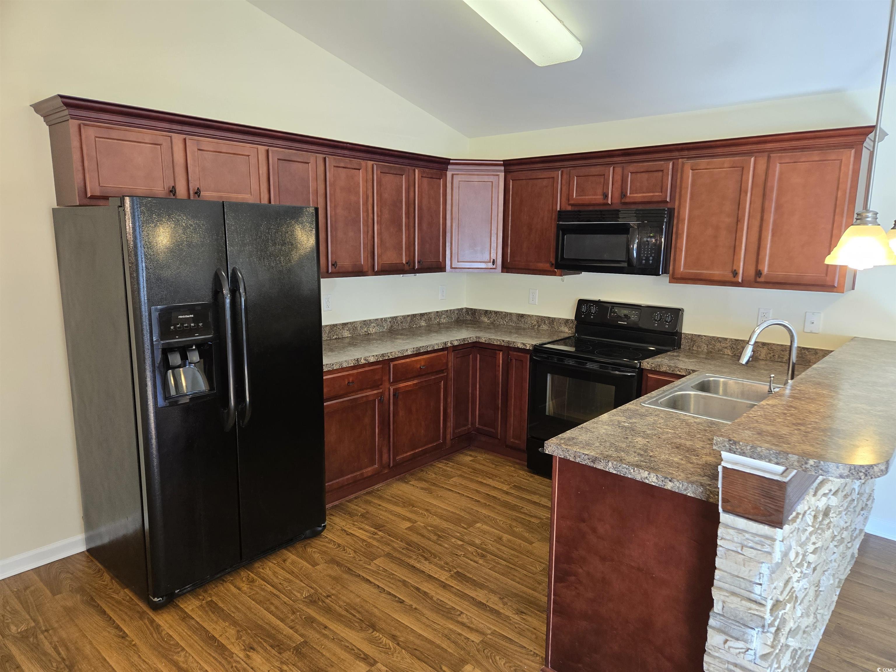 1245 Pine Ridge Street Conway, SC 29527 - Photo 9 of 28 Kitchen with black appliances, a peninsula, lofted ceiling, dark wood-style floors, and dark countertops