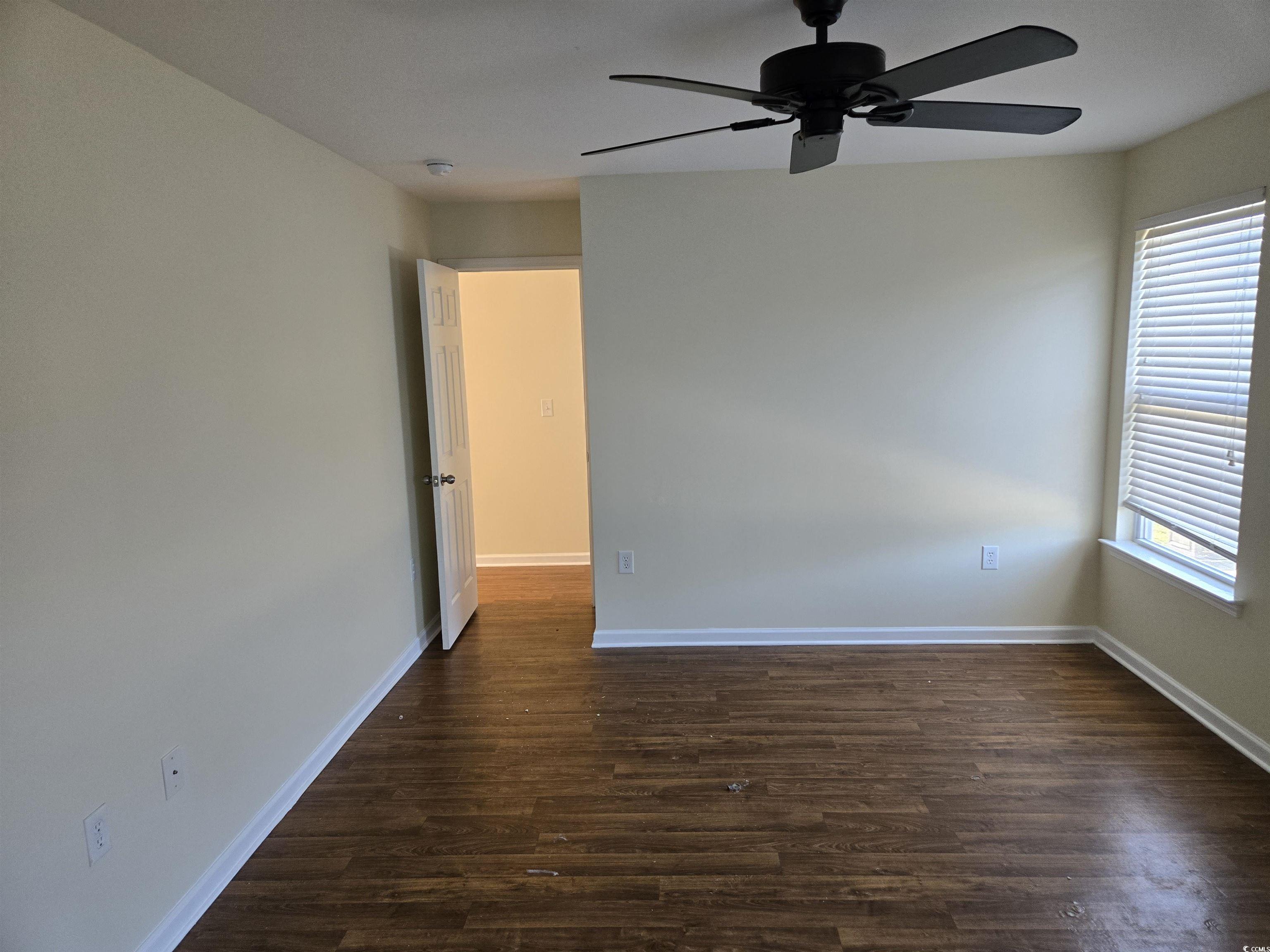 1245 Pine Ridge Street Conway, SC 29527 - Photo 10 of 28 Unfurnished room with dark wood-style floors and a ceiling fan