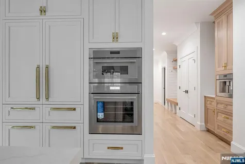 a kitchen with cabinets and stainless steel appliances