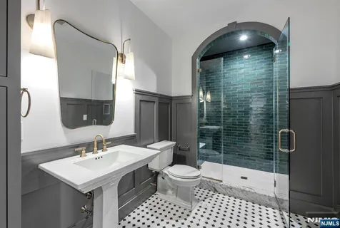 an empty room with windows fireplace and wooden floor