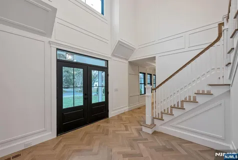 a view of entryway and hall with a front door