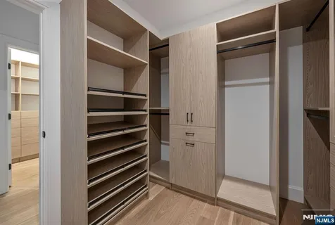 a bathroom with a granite countertop toilet sink and mirror