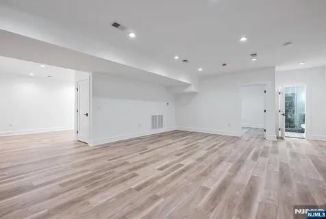 a kitchen with granite countertop wooden cabinets stainless steel appliances and a sink