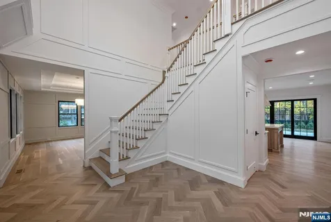 a view of entryway and hall with wooden floor