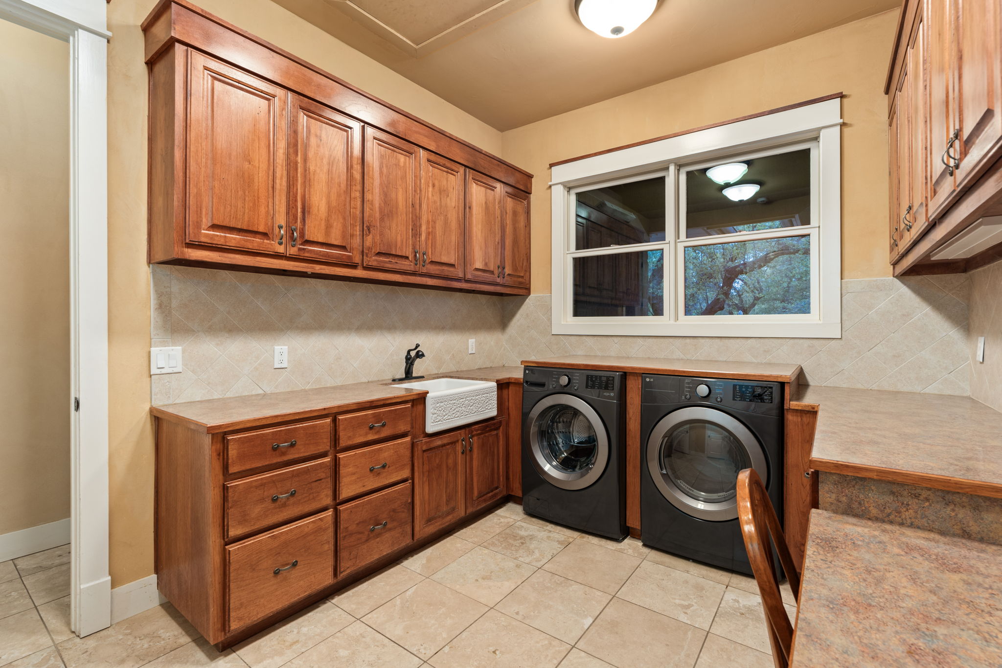 23426 Oscar Road Spicewood, TX 78669 - Photo 17 of 40 The laundry room is huge and features incredible storage and cabinet space.