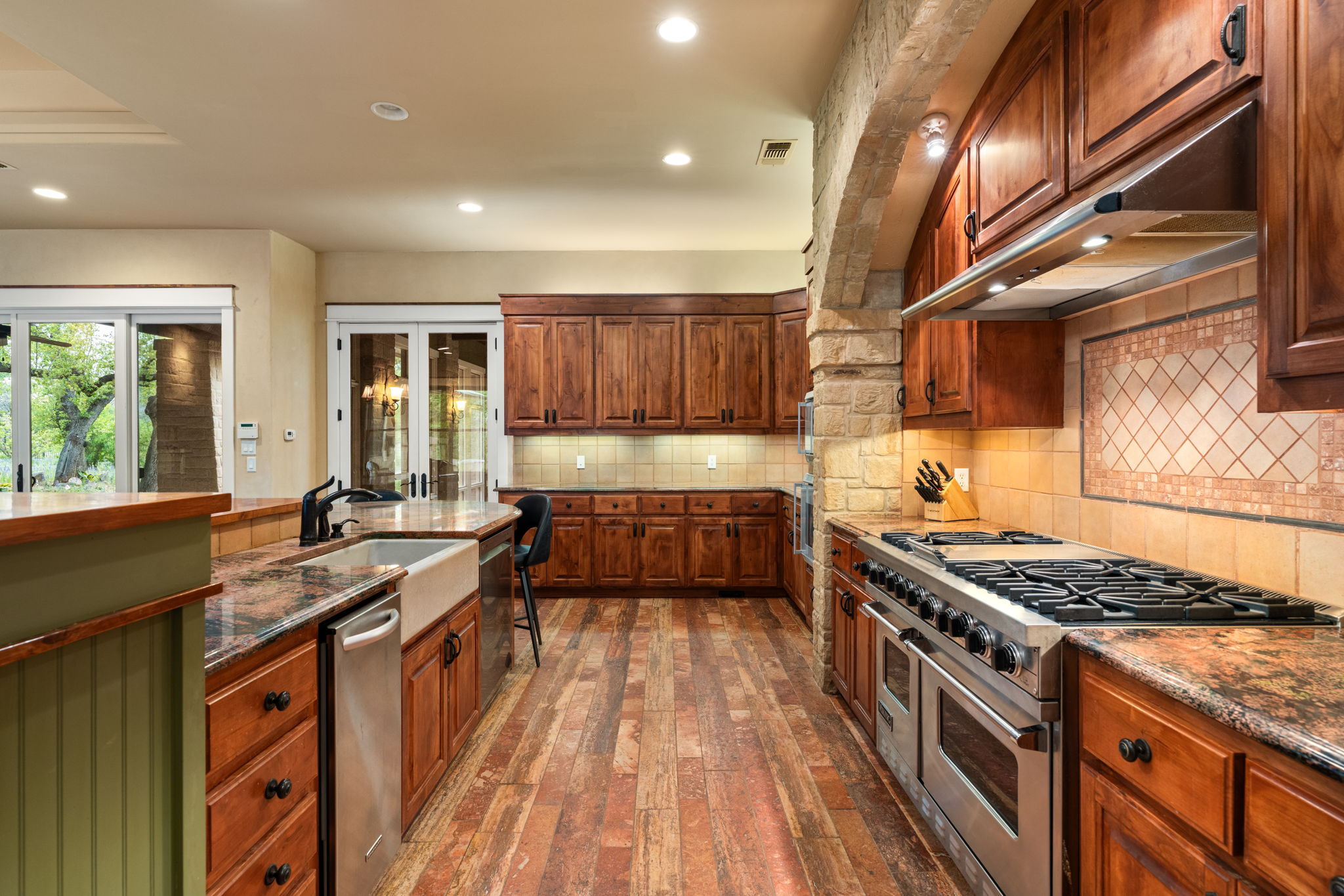 23426 Oscar Road Spicewood, TX 78669 - Photo 18 of 40 The kitchen has gorgeous granite countertops, a large island, and excellent storage space.