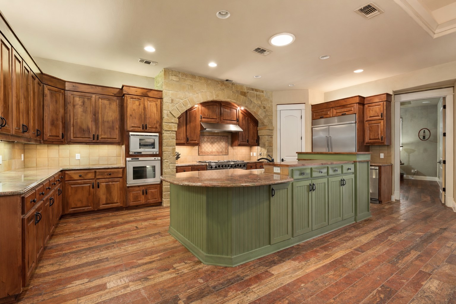 23426 Oscar Road Spicewood, TX 78669 - Photo 2 of 40 The spacious chef's kitchen features travertine floors and incredible high-end appliances.