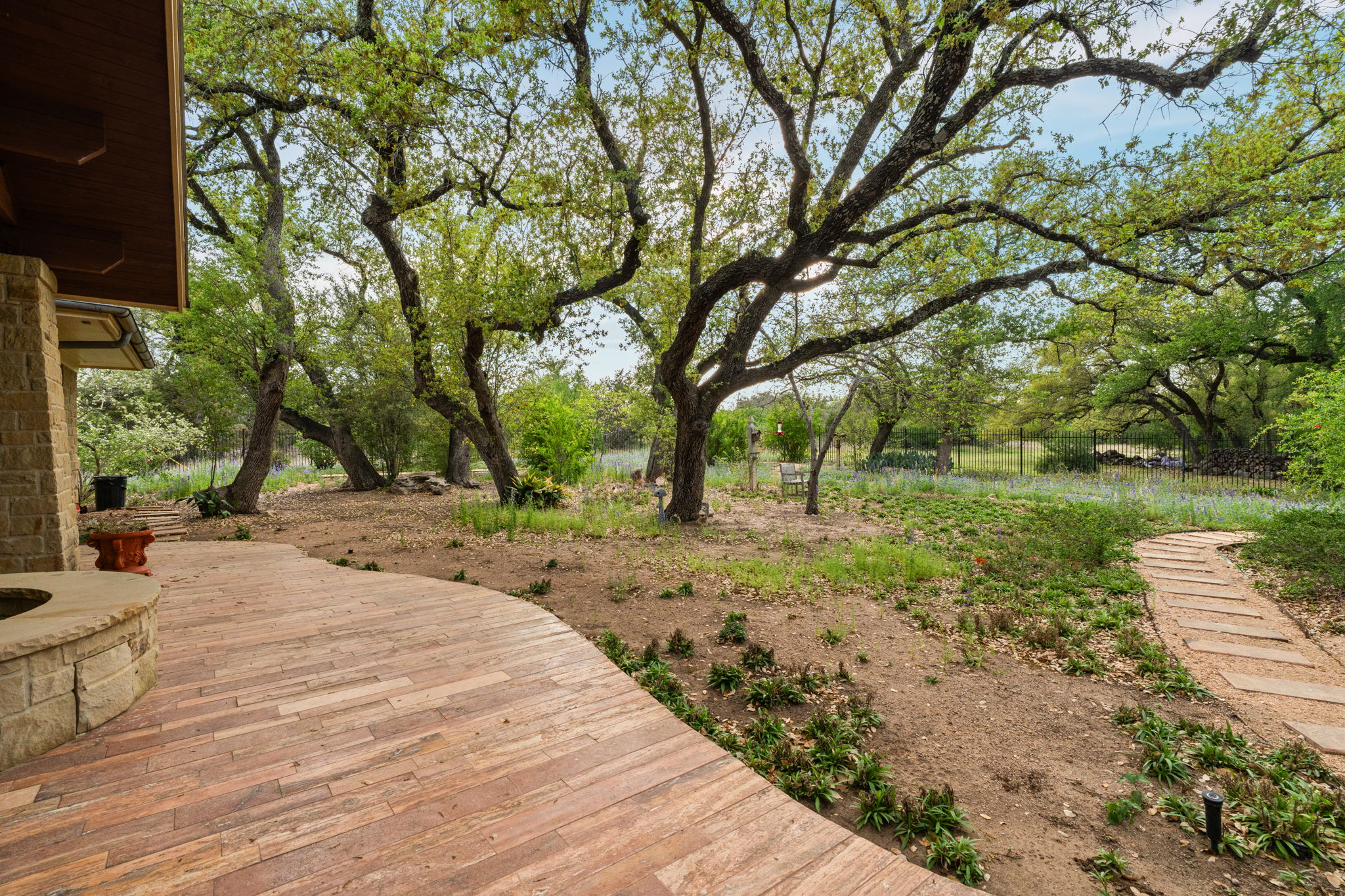23426 Oscar Road Spicewood, TX 78669 - Photo 26 of 40 Take in the views from the fenced backyard area off of the patio, which includes crushed granite and stone pathways.