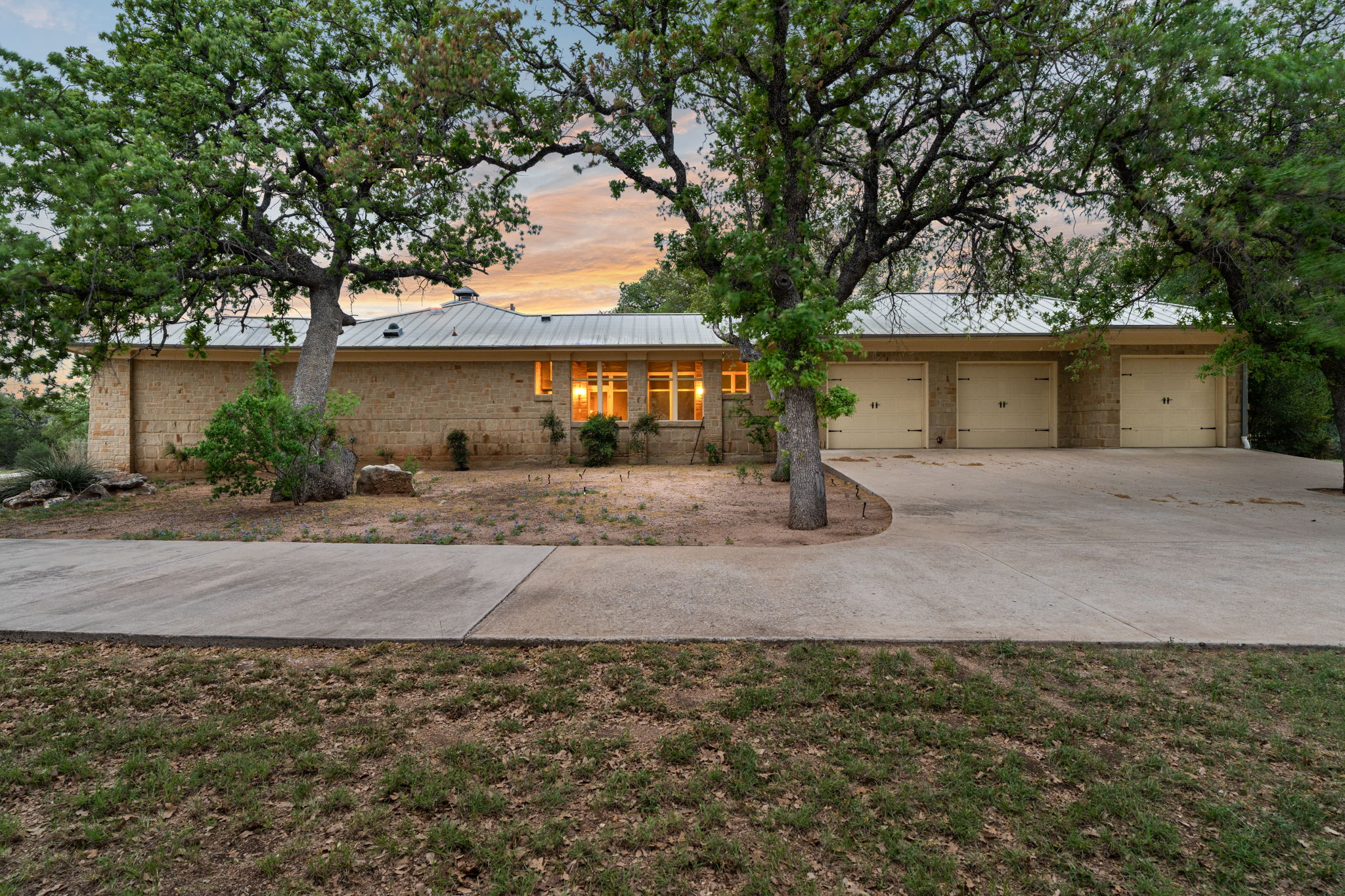23426 Oscar Road Spicewood, TX 78669 - Photo 27 of 40 The main house has an attached 3-car garage.