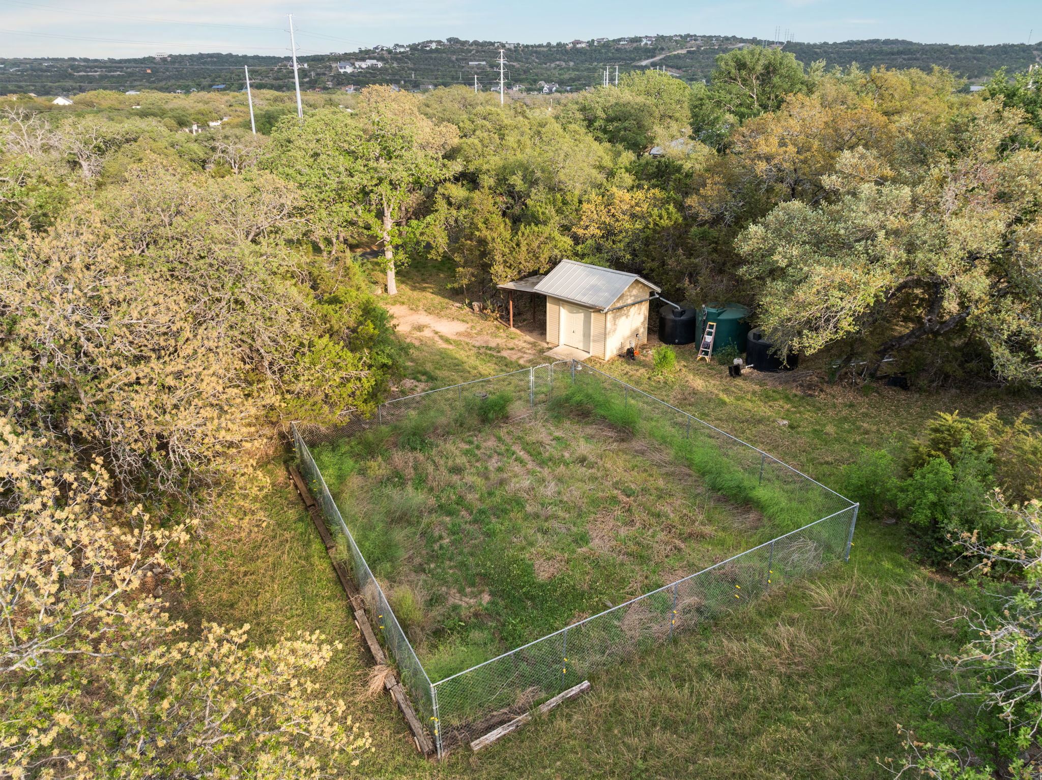23426 Oscar Road Spicewood, TX 78669 - Photo 37 of 40 The property has a large fenced garden area with irrigation. The main house and guest house both feature large rainwater collection systems, in addition to a well. There is also a well house on the property.