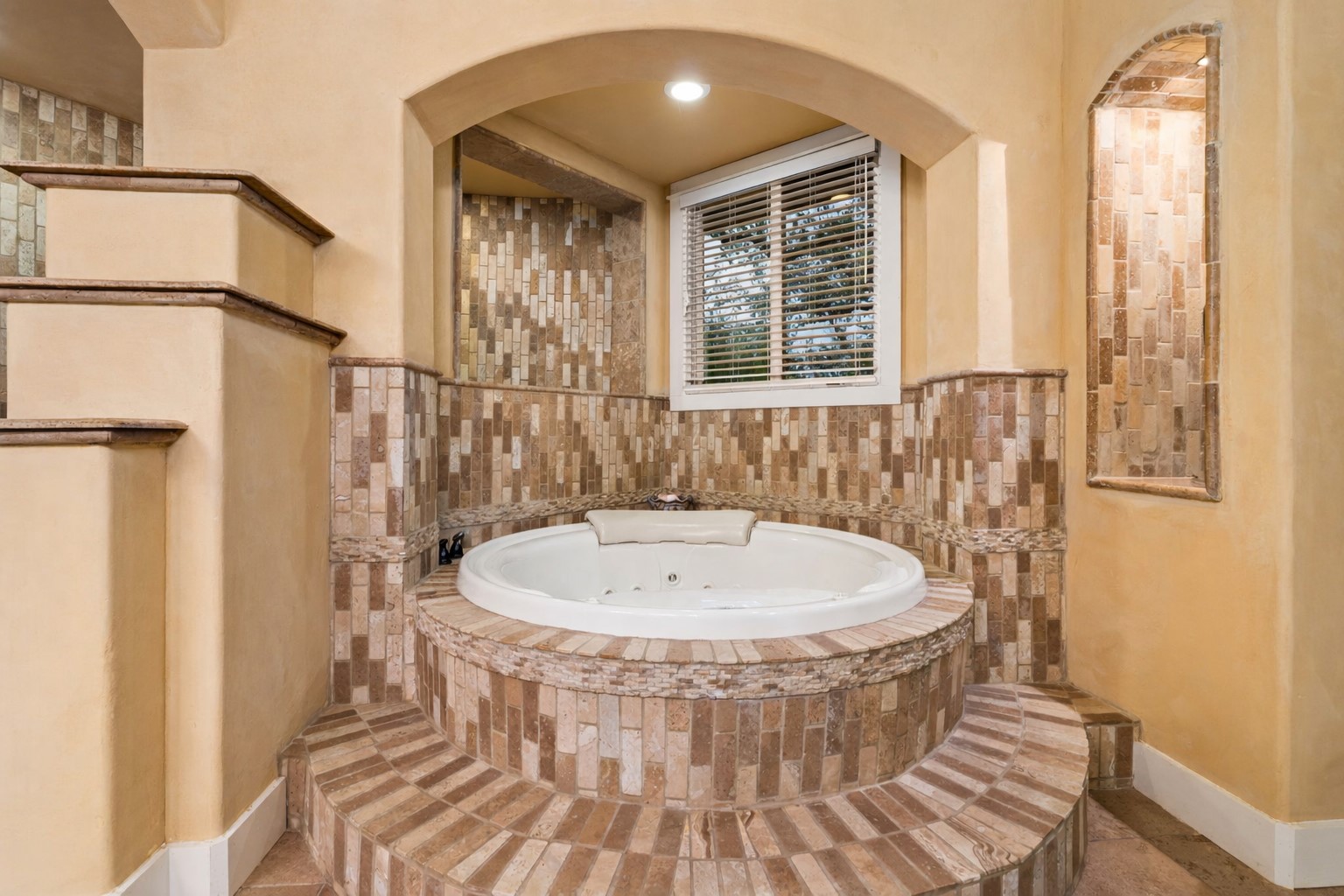 23426 Oscar Road Spicewood, TX 78669 - Photo 6 of 40 The primary bathroom has a massive jetted tub, huge walk-in shower, and a double vanity with storage.
The primary suite also has a massive closet with custom cabinets.