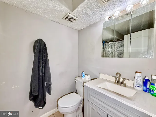 a white toilet sitting next to a bathroom sink