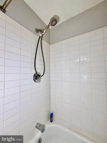 a bathroom with a shower and a shower head