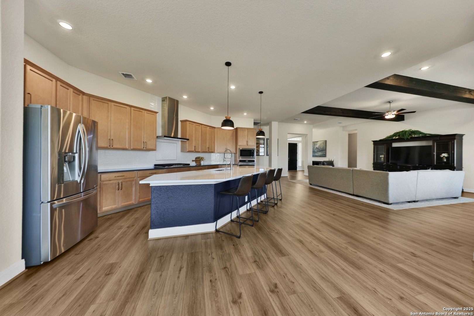 195 Piper Street Castroville, TX 78009 - Photo 11 of 47 a large kitchen with stainless steel appliances a large counter top a stove and a refrigerator