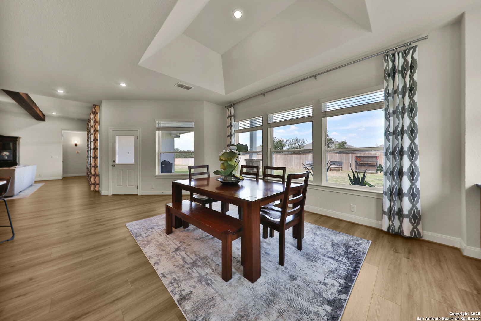 195 Piper Street Castroville, TX 78009 - Photo 15 of 47 a view of a dining room with furniture window and wooden floor