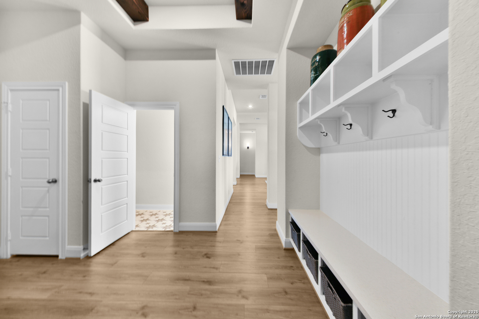 195 Piper Street Castroville, TX 78009 - Photo 18 of 47 a view of a hallway with wooden floor and staircase