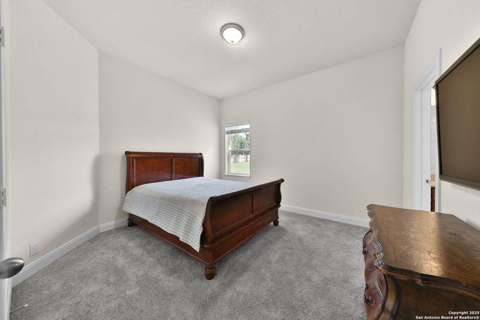 195 Piper Street Castroville, TX 78009 - Photo 20 of 47 a room with a bed and a chair