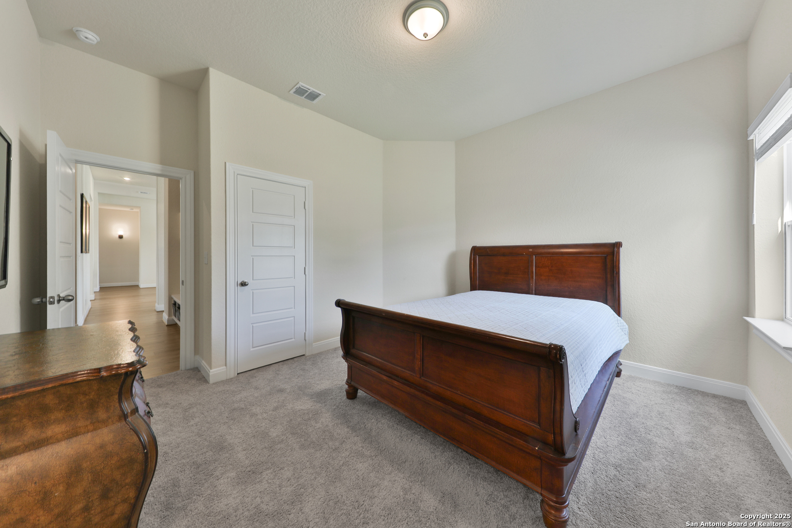 195 Piper Street Castroville, TX 78009 - Photo 21 of 47 a bedroom with bed and window