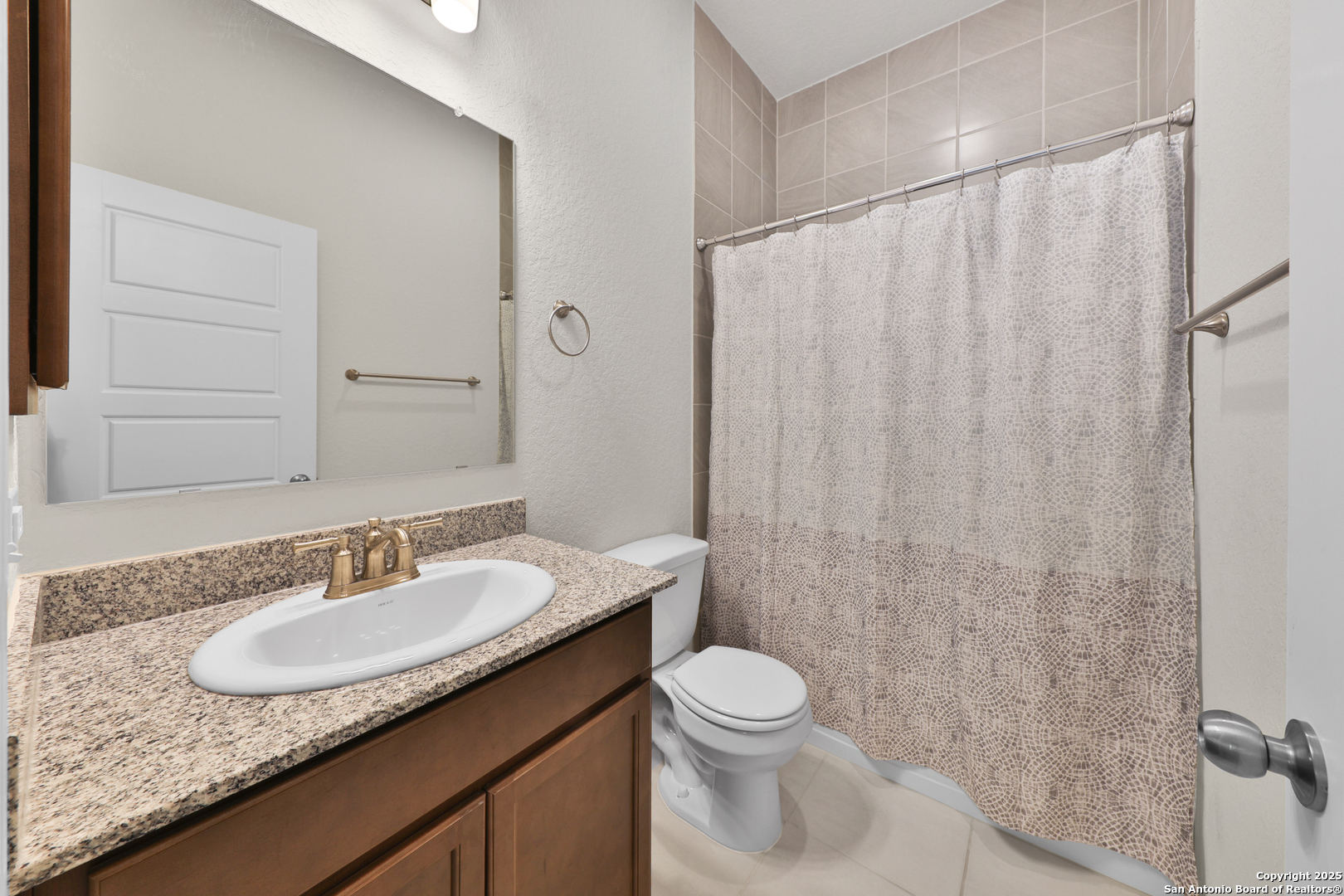 195 Piper Street Castroville, TX 78009 - Photo 22 of 47 a bathroom with a granite countertop sink and a mirror