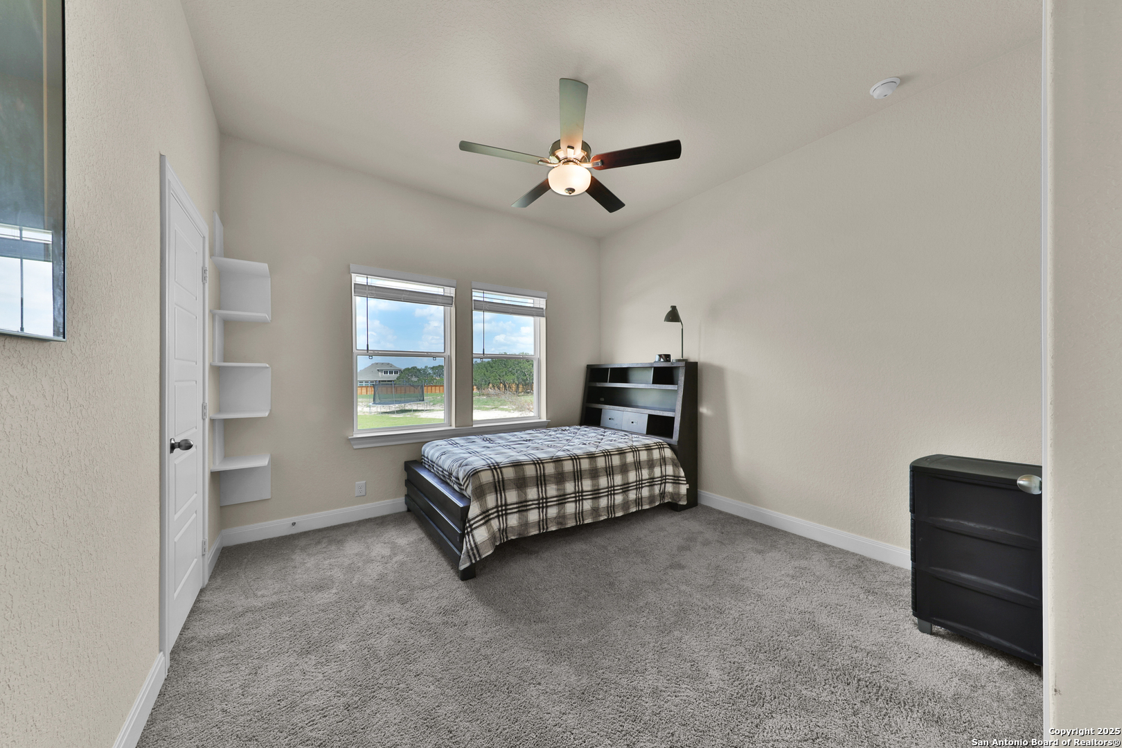 195 Piper Street Castroville, TX 78009 - Photo 25 of 47 a bedroom with a bed and a window