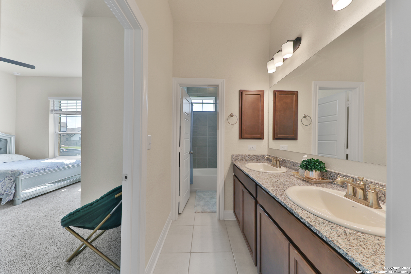 195 Piper Street Castroville, TX 78009 - Photo 27 of 47 a bathroom with a granite countertop double vanity sink and a mirror